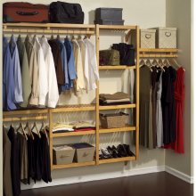 A closet with clothes hanging on racks.