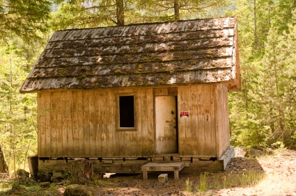 An old wooden cabin in the woods.