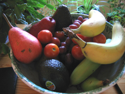 A bowl of fruit on a table.