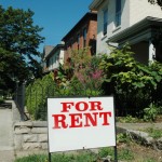 A for rent sign in front of a house.