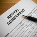 A rental agreement with a pen on top.