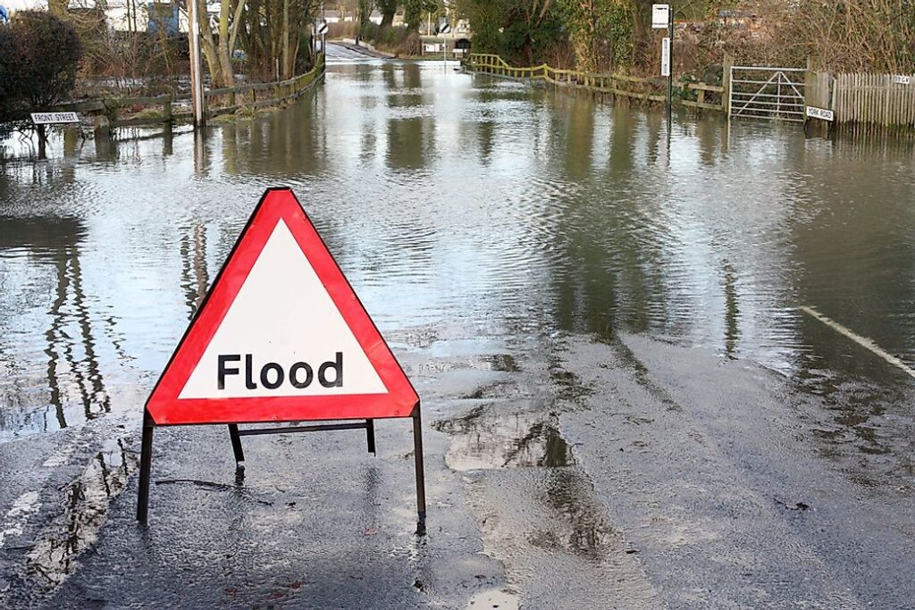 A Standing Flood Alert Signage on the road